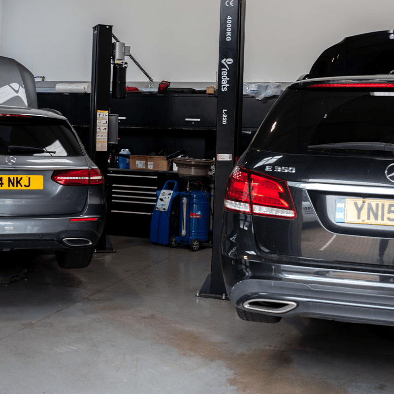 Two Mercedes in the workshop on low ramps_