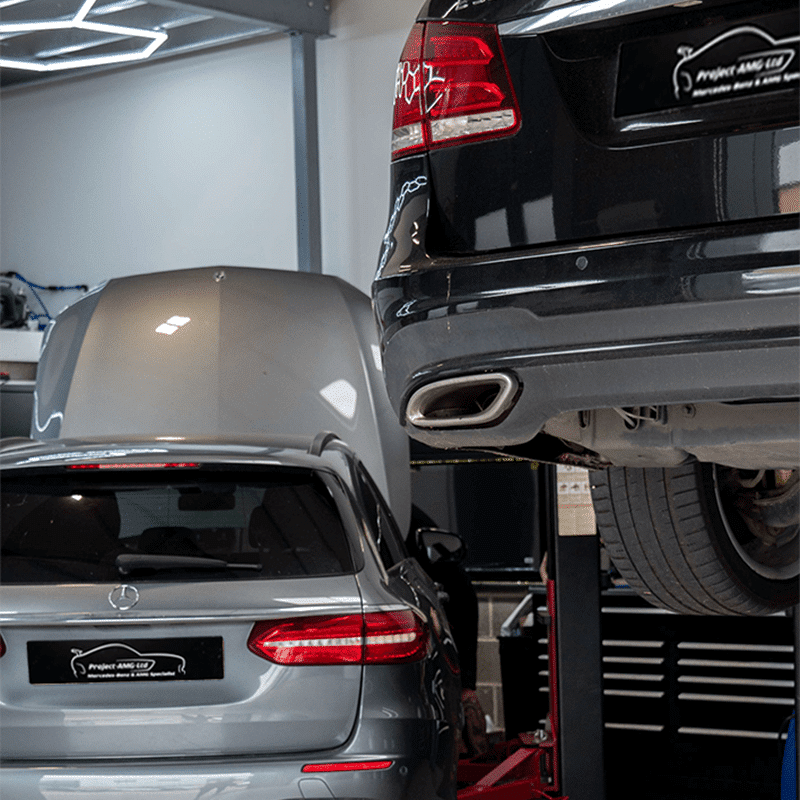 Two Mercedes in the workshop one high ramp one low